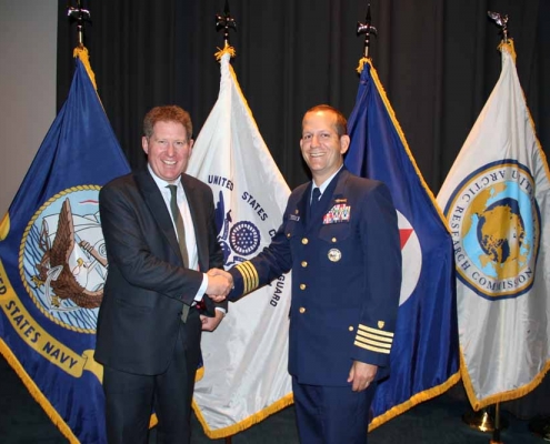 Michael Kingston receives the Challenge Coin Award from Capt John Mauger, Commanding Officer USCG Maritime Safety Centre HQ