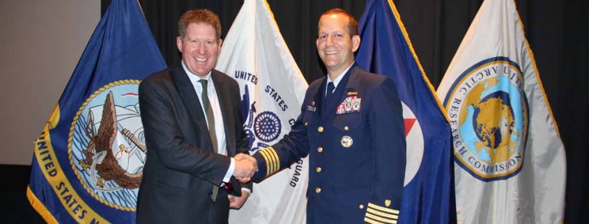 Michael Kingston receives the Challenge Coin Award from Capt John Mauger, Commanding Officer USCG Maritime Safety Centre HQ
